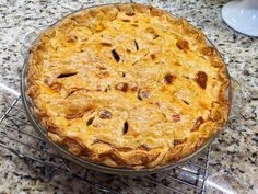 a pie sitting on top of a metal rack