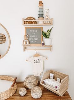 a baby's room with white walls and wooden furniture, including a wicker bassinet