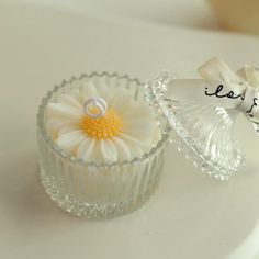 two small glass dishes with flowers in them