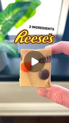 someone is holding a piece of food with the words reese's written on it