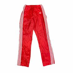 Vintage Adidas Trefoil Logo Men's Red White 3-Stripe Nylon Swishy Elastic Waist Warm Up Track Pants Tag Size MEDIUM Most pre-owned pants will not measure exact to the tag size. To insure fit, compare actual flat measurements below against your favorite pants at home. Flat Measurements: Waist: 13 in (minimum elastic) Rise: 12 in Inseam: 32 in Condition: This is a clean, quality pre-owned pair of pants. Signs of light wash and wear should be expected. Significant flaws will be listed below. Flaws: Adidas Three Stripes Pants For Streetwear, Sporty Red Full-length Sweatpants, Sporty Red Jogging Pants, Red Sporty Jogging Pants, Sporty Red Pants For Jogging, Adidas Sporty Parachute Pants For Streetwear, Red Adidas Athleisure Pants, Adidas Sporty Red Bottoms, Nylon Sports Bottoms With Side Stripes