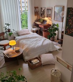 a bedroom with a bed, desk and chair in the corner next to a window