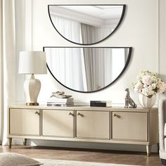 a living room with two mirrors on the wall