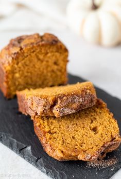 two slices of pumpkin bread on a slate board