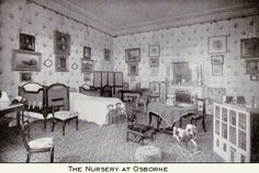 an old black and white photo of a room with chairs, desks and pictures on the walls