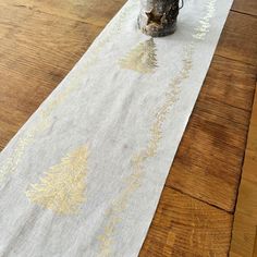 a white table runner with gold designs on it