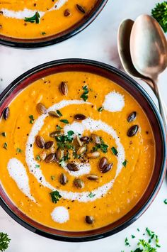 two bowls filled with soup and garnished with nuts