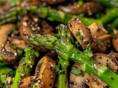 mushrooms and asparagus are mixed together in a dish that is ready to be eaten