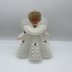 an angel figurine made out of white crochet