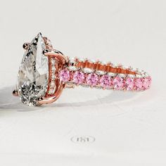 an engagement ring with pink and white stones