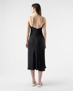 Loretta Midi Slip Dress in Black from Kamperett. Silk mid-calf slip dress with spaghetti straps. Featuring a straight cut neckline and a V at the back. Designed to be layered under the Meiere Midi Dress. 100% Silk Charmeuse Matte side out Sustainably and ethically made in California Sam is 5'8 and wearing size small Size Bust Waist Hip Length XS 30" 28" 42" 46" S 32" 30" 44" 46" M 34" 32" 46" 46" L 36" 34" 50" 46" XL 38" 36" 52" 47" 1X 40" 38" 54" 47" Kamperett Kamperett is a womenswear line fro Backless Slip Dress With Delicate Straps For Evening, Black Backless Bias Cut Slip Dress, Chic Cocktail Slip Dress With Adjustable Straps, Fitted Slip Dress With Straight Neckline For Daywear, Fitted Slip Dress With Delicate Straps For Daywear, Silk Dresses With Delicate Straps For Daywear, Sleek Slip Dress With Back Opening For Summer, Delicate Strap Camisole Slip Dress For Night Out, Camisole Slip Dress With Delicate Straps For Night Out