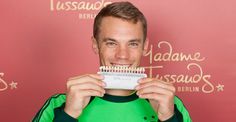 a man is holding up a toothbrush in front of his face and smiling at the camera