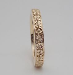 "This flower wedding band can made in 14k and 18k yellow, white and rose gold. The Band is hand carved, migrained and high polished. This band is approximately 3 mm wide and 1.7 mm average thickness 1.7. We can make it any size from 5 to 7 and you still be able to return it within the listed time frame. Email for pricing on sizes under 5 and sizes over 7. Available in 18K gold and platinum. Email for 18k gold platinum pricing. We love this ring because it represents the way jewelry should be mad Yellow Wedding Ring, Carved Wedding Ring, Floral Wedding Band, Flower Wedding Band, Vintage Floral Wedding, Jade Wedding, Wedding Band Gold, Floral Wedding Ring, Floral Wedding Bands