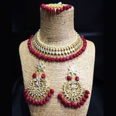 Gold Rodium Polish Red and Maroon color Necklace in Metal Alloy studded with CZ Diamond, Kundan Red Hand Set Kundan Necklace, Red Stone Work Jewelry Sets For Gifts, Red Metal Necklaces With Jewels, Heavy Red Necklaces For Festive Occasions, Red Jeweled Metal Necklaces, Red Ruby Choker Necklace, Red Jeweled Kundan Jewelry, Red Hand Set Kundan Necklace For Party, Red Kundan Jewelry For Party