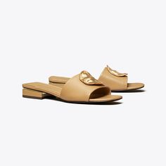 Our Patos sandal is defined by an oversized metal disc, evocative of ’60s glamour. Crafted in soft leather with a cushioned insole, it’s set on an understated block heel for a slight lift. 60s Glamour, Miller Sandal, Plastic Heels, Flat Mules, Mule Sandals, Footwear Design Women, Designer Sandals, Mule, Calf Leather