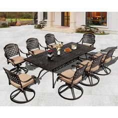 an outdoor dining table with eight chairs around it