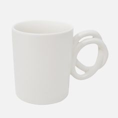 a white coffee cup with two interlocked handles