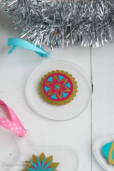 an ornament is sitting on a table next to some tinsel and ribbon