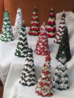 small christmas trees made out of paper on a table