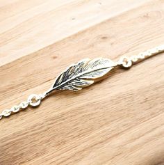 Discover the perfect blend of elegance and bohemian charm with our stunning 925 Sterling Silver Feather Bracelet. Handcrafted with love and precision, this exquisite piece is designed to be both versatile and timeless. Adorn your wrist with a delicate feather motif, meticulously crafted from premium 925 sterling silver, ensuring you shine with a touch of nature-inspired beauty. Measuring 7/8 inches in width and 3/16 inches in length, this bracelet is adjustable from 6 1/2 inches to 7 1/2 inches, making it a perfect fit for any wrist size. Crafted with the highest quality materials, this sterling silver bracelet is stamped with the coveted 925 mark, symbolizing its purity and authenticity. Whether you're dressing up for a special occasion or adding a touch of sophistication to your everyday Bohemian Sterling Silver Bracelets For Party, Bohemian Sterling Silver Bracelet For Parties, Bohemian Sterling Silver Party Bracelets, Silver Bohemian Charm Bracelet For Party, Bohemian Bracelets With Lobster Clasp For Party, Bohemian Party Bracelets With Lobster Clasp, Feather Bracelet, Silver Feather, Anniversary Present