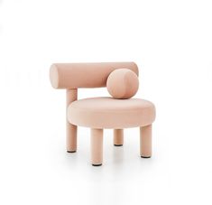 a pink chair sitting on top of a white floor next to a wooden stool with an object in the middle