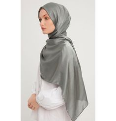 Shine Hijab Shawl - Sage Grey Glossy in texture and elegant in appearance, our shine shawl is set to be the next great addition to your wardrobe! Its sleek shine makes for an impressive final touch to formal wear so you could look and feel your best on any special occasion. FEATURES: - Glossy finish - Suitable for all seasons - Opaque (not transparent) MATERIAL: - 75 cm x 185 cm - Polyester CARE: - Hand wash separately in cold water. - Lay flat to dry. - Iron on low without steam. Made in Turkey Elegant Shawl For Eid And Formal Occasions, Elegant Shawl For Formal Eid Occasions, Elegant Formal Shawl For Eid, Elegant Silk Shawl For Eid, Elegant Silk Scarf For Eid, Elegant Satin Dupatta For Formal Occasions, Elegant Formal Satin Dupatta, Formal Solid Color Satin Scarves, Elegant Silver Dupatta For Formal Occasions