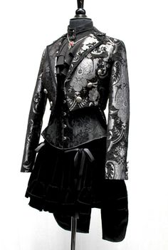 An elegant women's formal coat with tails. A Victorian style women's tailcoat cut short in the front with extra long curving tails in back. Made in elegant tapestry fabric with ornate metal buttons on either side in the front and two at the waist in back. Smaller metal buttons at each cuff. The tails are split in the center back for easy movement and classic style!. Braided trim decorates the collar. Completely lined on the inside in sleek black satin. Comes in sizes Small-3X. Gorgeous!! Size me Womens Tailcoat, Formal Goth, Vest Tailcoat, Purple Tail Coat, White Tailcoat, Goth Tailcoat, Formal Coat, Tapestry Fabric, Dress Design Sketches