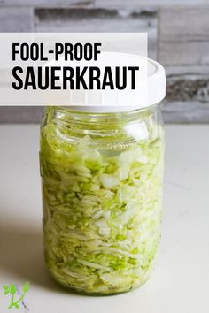 a jar filled with shredded cabbage sitting on top of a table