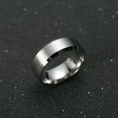 a silver ring sitting on top of a black table