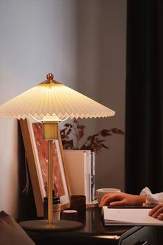 a lamp sitting on top of a table next to a laptop computer