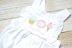 This listing is an adorable knit ruffle bubble romper with sweets trio (donut, cupcake, and ice cream) and name!  This is a perfect cake smash outfit for an ice cream, donut or summer birthday party.     Available in 3M, 6M, 9M, 12M, 18M, 2T and 3T.  These bubbles run about a size big.  Message me with questions. In Notes to seller please include:  1)  Choice of FABRIC/color scheme 2) NAME or FULL name for monogram 3) Font choice for name Current Processing time in Shop Announcement on homepage Cute Fitted Bubble Romper For First Birthday, Sweet Pink Bubble Romper For Birthday, Fitted Cotton Bubble Romper In Sweet Style, Playful Fitted Bubble Romper For Birthday, Cute Fitted Bubble Romper For Birthday, Fitted Bubble Romper With Ruffles For Birthday, Fitted Ruffles Bubble Romper For Birthday, Sweet Cotton Bubble Romper For First Birthday, Sweet White Bubble Romper For First Birthday