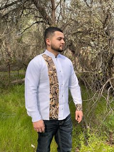 This Guayabera Shirt is a Traditional Mexican Shirt that never goes out of style. It is Stylish, Fresh and Comfortable. This Elegant Collared shirt is perfect for everyday use, Vacation and or any Special occasion. White Long sleeve with Gold embroidery Stripe detail and on one of the cuffs. - Made in Mexico  - Elegant Shirt We are not responsible for Stolen, late or Lost packages due to mail carriers. Message us if you have any questions.  * More Guayaberas styles Avaible click links to view. https://www.etsy.com/CositasBonitasByAri/listing/1429673383/guayabera-men-long-sleeve-mexican-shirt?utm_source=Copy&utm_medium=ListingManager&utm_campaign=Share&utm_term=so.lmsm&share_time=1677962341769 https://www.etsy.com/CositasBonitasByAri/listing/1416914002/guayabera-men-long-sleeve-mexican-shir Traditional Long Sleeve Wedding Shirt, Traditional Fitted Shirt With Buttons, Fitted Traditional Collared Shirt, Traditional Fitted Long Sleeve Shirt, Traditional White Button-up Shirt, Traditional Mexican Shirts, Mexican Shirts, Wedding Party Shirts, Guayabera Shirt