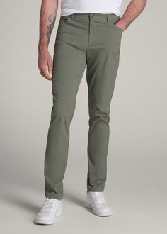 About Our Men's Tall Travel Pants You've got places to go, and these tall men's pants will help you get there. Sturdy yet comfortable, practical yet stylish, these pants are super versatile and can be worn everywhere from walking through the grocery store to trekking through the mountains and teeing off on the golf course. We know the struggle of finding pants for tall men, with inseams that hit awkwardly above the ankle or fits that are baggy in all the wrong places. This pair was crafted exclu Green Pants With 4-way Stretch And Pockets, Green Pants With Pockets And 4-way Stretch, Green 4-way Stretch Pants With Pockets, Tall Men, Travel Pants, Chino Jeans, Tall Guys, Golf Course, Grocery Store