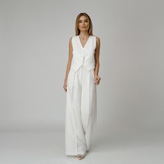 Introducing our Dove Silk Crepe Pants, a statement of luxurious comfort and timeless style. Tailored from white silk crepe with a wide-leg cut, they feature expertly placed darts that contour the waist and flatter the silhouette. The pressed crease detail offers a touch of refinement, elevating the overall look with understated polish. A concealed zipper and hook fastening in the front ensures a seamless finish, while the inclusion of pockets adds a practical yet chic element to the ensemble.  M Modern White Wide Leg Pants For Formal Wear, Modern White Wide Leg Pants For Formal Occasions, Modern White Formal Wide Leg Pants, Tailored White Wide Leg Pants, Modern Formal Wide Leg Pants For Summer, Modern Wide Leg Pants For Summer Formal Events, Modern Wide Leg Pants For Summer Formal Occasions, Elegant White Wide Leg Pants, White Wide Leg Pants For Summer Evenings