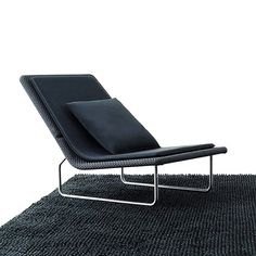 a black chair sitting on top of a rug