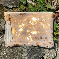 This Breccia clutch is a beautiful bag that is great for so many occasions, or for use everyday with style! Dimensions: Height: 18cm (7.08in) Width: 24cm (9.4in) Flat construction It is made from hair on cowhide in metallic bronze on the front with soft, cream leather on the back or you can choose cowhide on both sides - please see the Material options below.  The Breccia has a cotton, light fawn lining with gold stars and a handy credit card sized pocket inside. It has  a pretty YKK gold colour Gold Leather Handheld Evening Bag, Gold Cosmetic Bag With Removable Pouch, Elegant Gold Cosmetic Bag With Removable Pouch, Beige Clutch Cosmetic Bag, Elegant Gold Evening Bag For Daily Use, Elegant Gold Cosmetic Bag For Everyday, Gold Leather Pouch For Daily Use, Gold Clutch With Removable Pouch For Daily Use, Evening Clutch Cosmetic Bag With Zipper