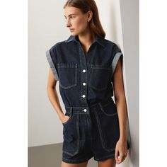 Blue denim (100% Cotton). Romper. Short sleeves. Collared. Front button closure. 32.5" from shoulder to hemline. 9" inseam. Imported. Trendy Collared Denim Jumpsuit, Collared Denim Jumpsuit With Pockets, Short Sleeve Denim Vest With Pockets, Denim Vest With Pockets And Short Sleeves, Casual Collared Denim Jumpsuit With Pockets, Collared Denim Jumpsuit With Button Closure, Fitted Collared Denim Jumpsuit For Summer, Summer Collared Denim Jacket With Pockets, Button-up Denim Vest For Work With Pockets