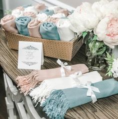 the table is set with towels, flowers and cards for guests to write on them