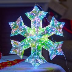 a lighted snowflake sitting on top of a table