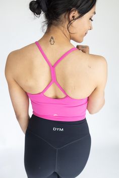 IDEAL FOR: Yoga + Barre + Pilates, Dance, Low Impact Workout, Cardio, Casual Wear. FEELS LIKE: Designed with a lightweight fabric which is incredibly soft and features 4-way stretch and high retention. WHY WE LOVE THEM: Just like our original Fan-favorite Solar Tank- but with extended tummy coverage, size options, and sporting our gold logo! We LOVE this top because it can be worn on it's own as a tank or layered underneath as a bra. This top features a flattering V-neckline with a unique gather Compressive Sleeveless Activewear With Built-in Bra, Activewear With Built-in Bra And T-back, Yoga Tank Top With Built-in Bra And 4-way Stretch, Functional High Stretch Tank Top With Built-in Bra, Versatile Yoga Tank Top With Built-in Bra, Athleisure Stretch Tank Top With Built-in Bra, Versatile Activewear With Built-in Bra And Tank Straps, Fitted T-back Activewear For Yoga, Functional Tank Activewear With Built-in Bra