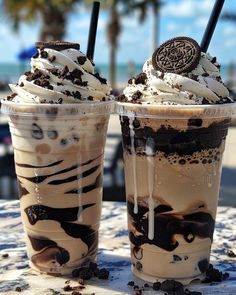 two ice cream sundaes with oreo cookies on top are sitting next to each other