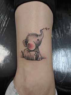 an elephant tattoo on the ankle with music notes coming out of its trunk and ears