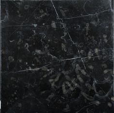 a black marble textured background with white and gold designs on the top right corner