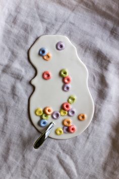 a white plate topped with lots of colorful donuts