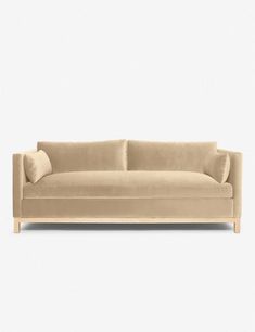 a beige couch sitting on top of a white floor