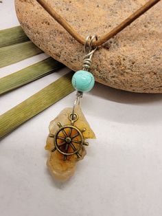 This raw fire agate stone was hand collected in California.   Give the gift of adventure with this ship wheel charm necklace. A unique affordable piece of jewelry for your partner is a great way to remember a trip together, or to show a loved one you're thinking about them.   Real brown leather cord is 20" long. Lobster clasp. Unique vibes, unique style... only from Grumbly Tumbleweed. Rustic Agate Jewelry Gift, Rustic Agate Jewelry For Gifts, Rustic Gemstone Jewelry For Gifts, Nautical Style Adjustable Jewelry Gift, Adjustable Nautical Style Jewelry For Gifts, Adjustable Anchor-shaped Necklace For Gifts, Rock Crystal Jewelry, Apache Junction, Ship Wheel