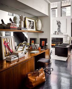 a living room filled with lots of furniture and decor on top of a hard wood floor