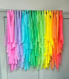 rainbow colored streamers hanging on the wall