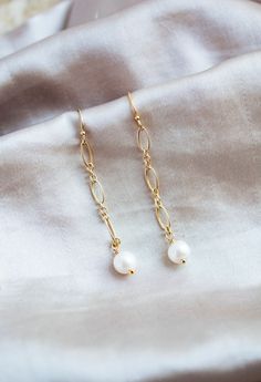 This listing is for a pair of freshwater pearl and 14k gold filled earrings. All gold accessories are 14k gold filled. The white freshwater pearls measure 6 mm. These earrings are 1.5 inches long. Perfect for everyday wear, weddings, gifts, and more! Please check out the matching freshwater pearl and 14k gold filled necklace here -https://wildcollections.etsy.com/listing/668016373 Please check out the matching freshwater pearl and 14k gold filled bracelet here -  https://wildcollections.etsy.com/listing/649806865 Nickel-free 14k Gold-filled Pearl Earrings, 14k Yellow Gold Filled Dangle Pearl Earrings, Delicate Gold Linear Earrings With Pearl Drop, Gold Linear Earrings With Pearl Charm As Gift, Gold Pearl Earrings With 14k Ear Wire, Gold 14k Gold Pearl Earrings With Ear Wire, Dainty Linear Earrings With Pearl Charm For Gift, 14k Gold Filled Pearl Earrings For Gifting, Dainty Gold Linear Earrings With Pearl Charm