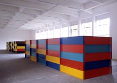 an empty room with multiple colored blocks on the wall